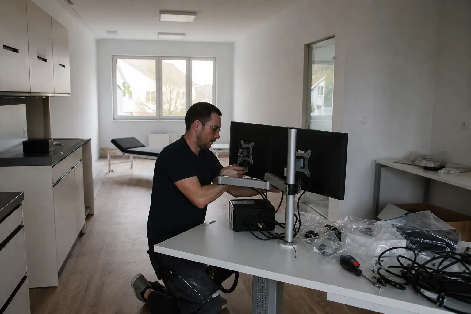 Techniker montiert und verkabelt neue Praxisarbeitsplätze.